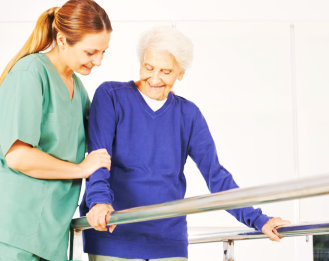 a female caregiver assisting an elderly woman