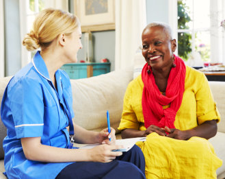 a female caregiver and a female patient talking